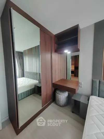 Modern bedroom with stylish wooden wardrobe and cozy bed