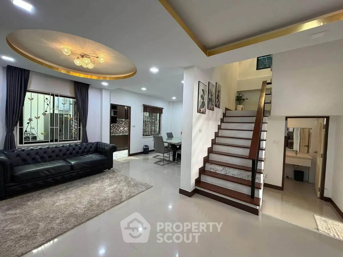 Spacious modern living room with elegant staircase and stylish decor
