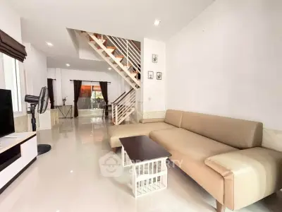Spacious modern living room with elegant staircase and stylish furniture