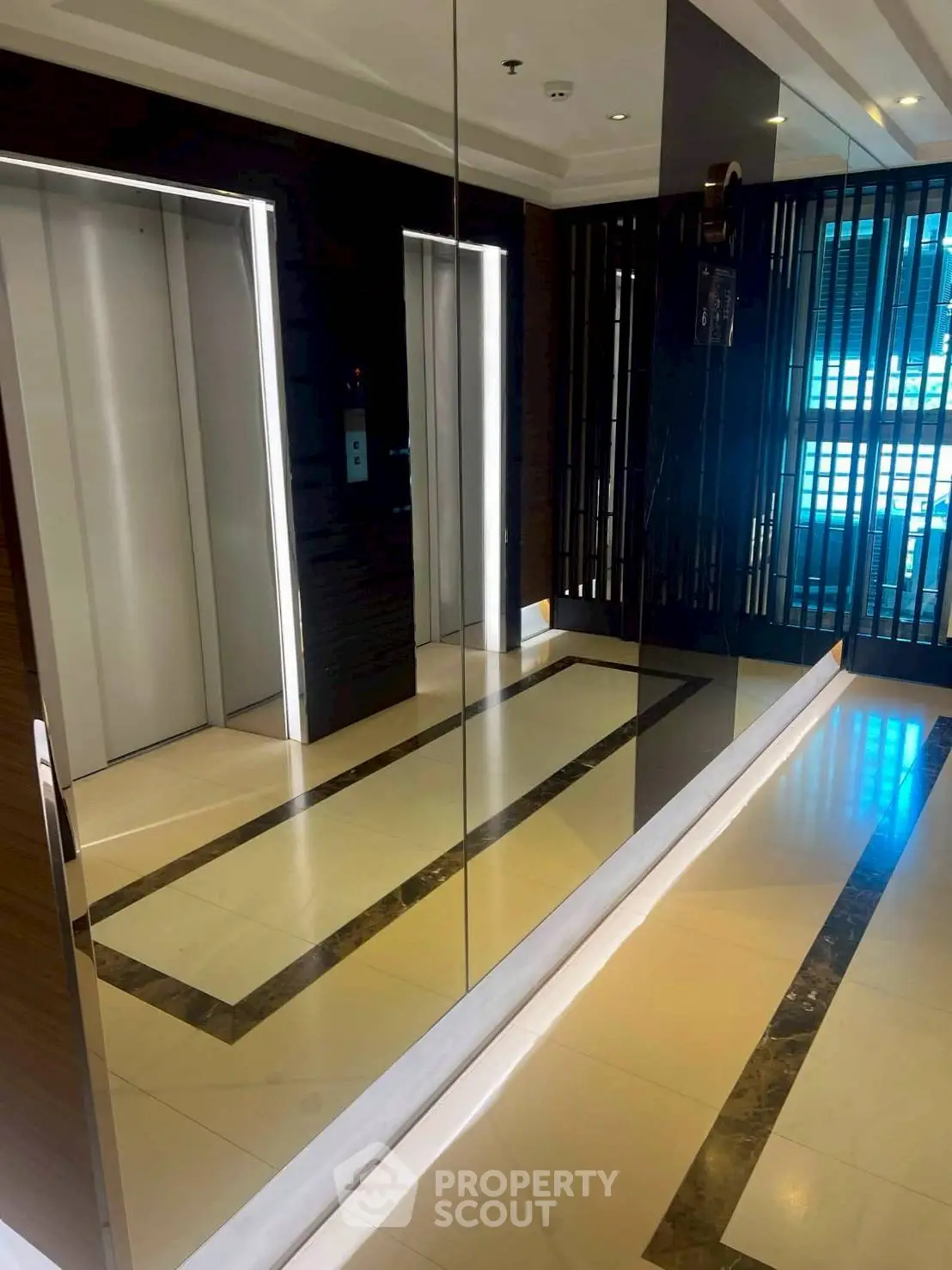 Modern building elevator lobby with sleek design and mirrored walls