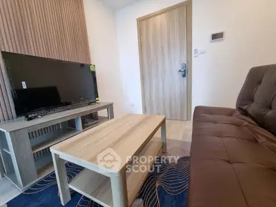 Modern living room with sleek furniture and flat-screen TV, perfect for cozy relaxation.
