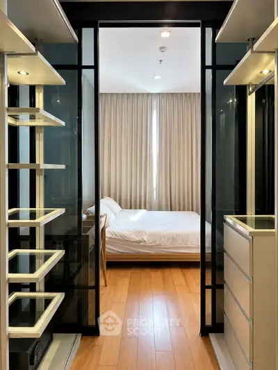 Modern bedroom with wooden flooring and sleek storage solutions