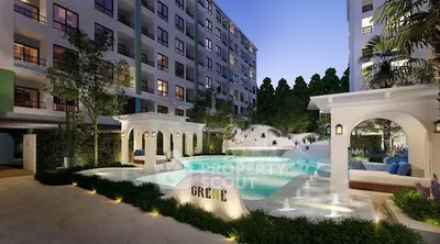 Luxurious apartment complex with stunning pool and elegant outdoor seating area.