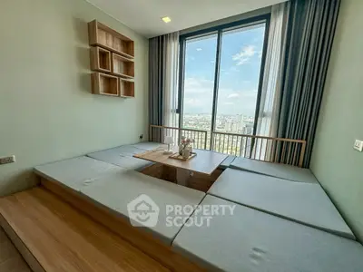 Modern living room with panoramic city view and minimalist furniture design.