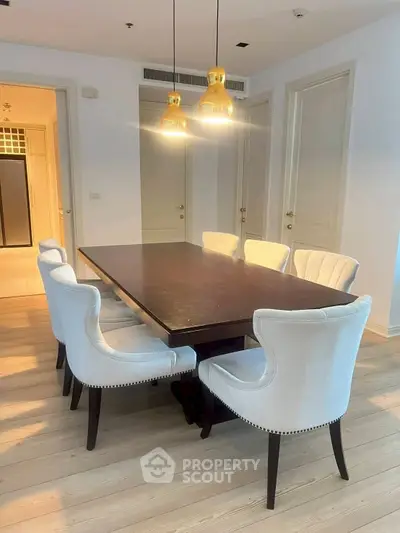 Elegant dining area with modern lighting and stylish chairs
