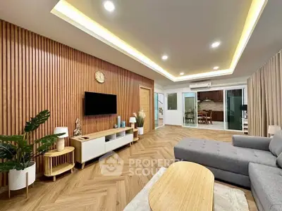 Modern living room with stylish wooden paneling and open layout