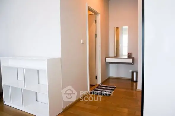 Modern apartment hallway with wooden flooring and minimalist decor