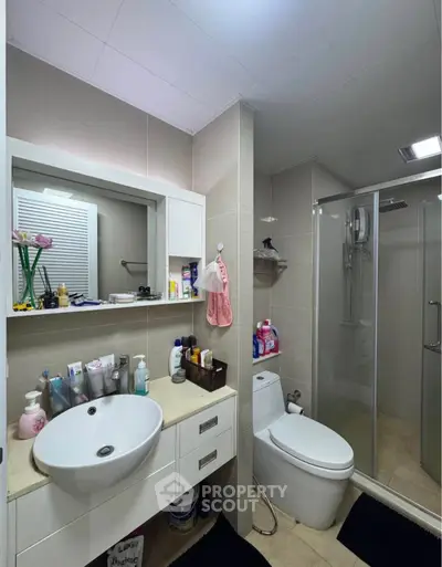 Modern bathroom with sleek fixtures and glass shower enclosure