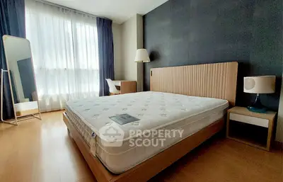 Spacious bedroom with modern furnishings and natural light