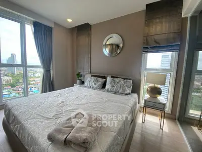 Modern bedroom with city view, featuring elegant decor and large windows for natural light.