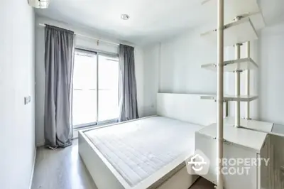 Bright minimalist bedroom with large window and modern shelving unit