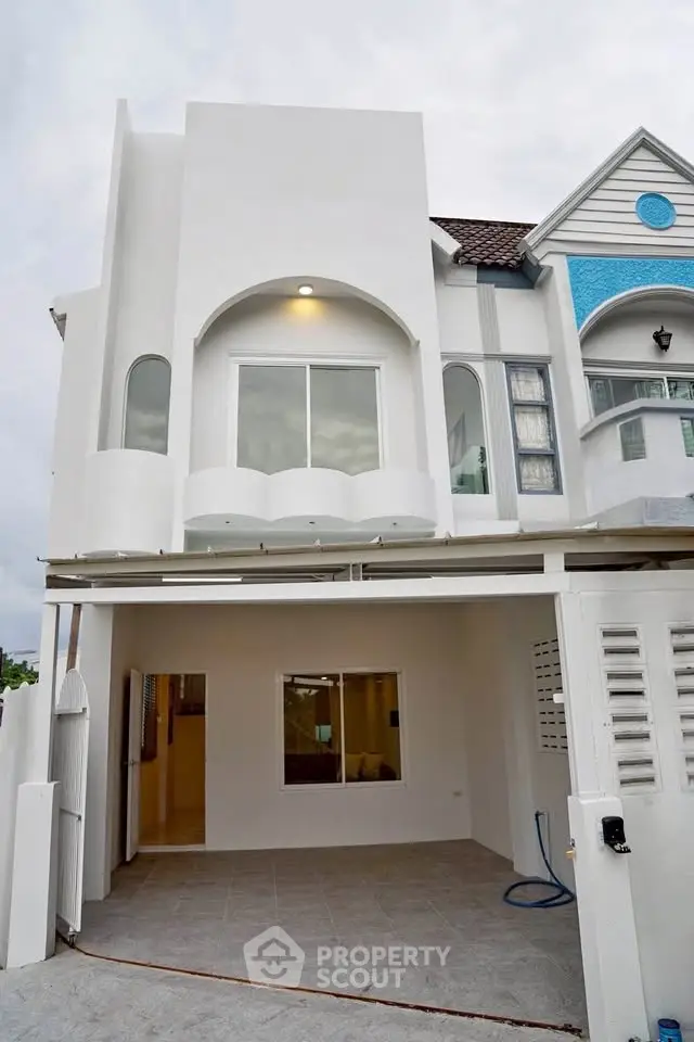 Modern townhouse exterior with clean lines and spacious garage area, perfect for contemporary living.