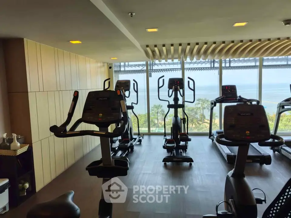 Modern gym with ocean view and state-of-the-art exercise equipment