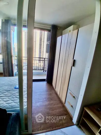 Modern bedroom with balcony view in high-rise apartment