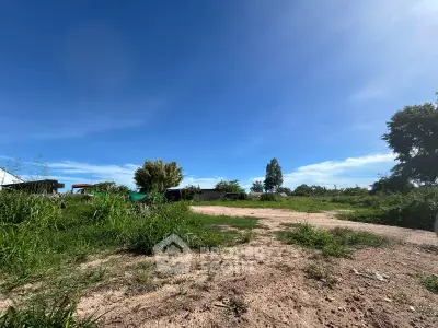 Expansive vacant land with clear blue sky, ideal for development opportunities.