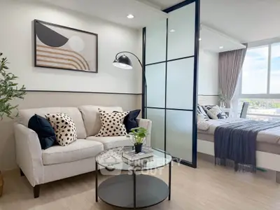 Modern living room with cozy sofa and stylish decor adjacent to a bright bedroom with large window.