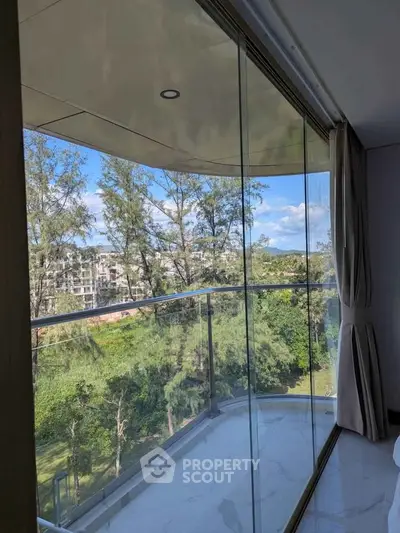 Stunning balcony view with lush greenery and modern glass railing