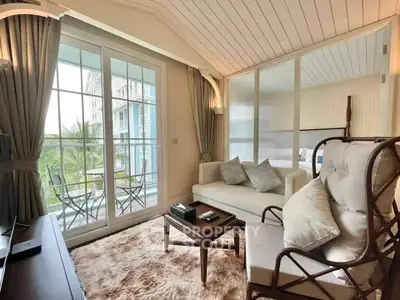 Charming living room with cozy seating and balcony view in elegant apartment