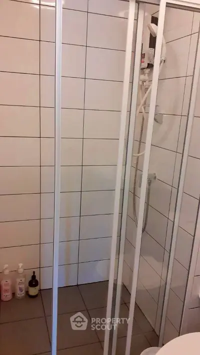 Modern bathroom with sleek shower enclosure and tiled walls