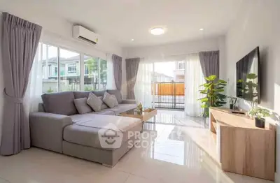 Bright and spacious living room with modern decor and large windows in a stylish home.