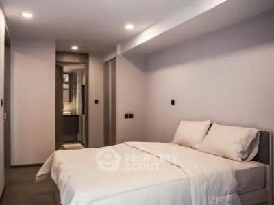 Modern minimalist bedroom with cozy lighting and sleek design