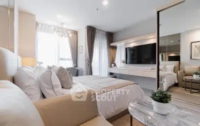 Luxurious modern bedroom with elegant decor and large TV