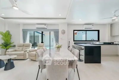 Modern open-plan living and dining area with sleek kitchen design