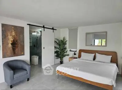 Spacious modern bedroom with ensuite bathroom and stylish decor