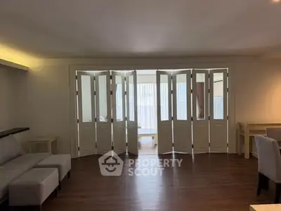 Spacious living room with elegant folding doors and modern furniture