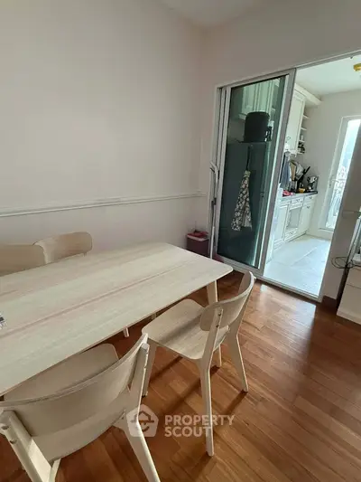 Charming dining area with wooden flooring and open kitchen layout