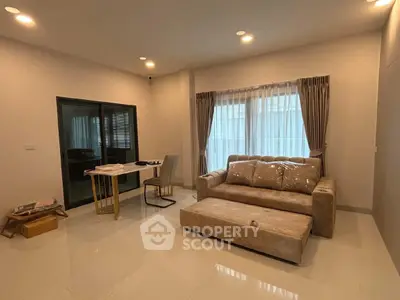 Spacious living room with modern sofa and elegant curtains, perfect for relaxation and entertaining.