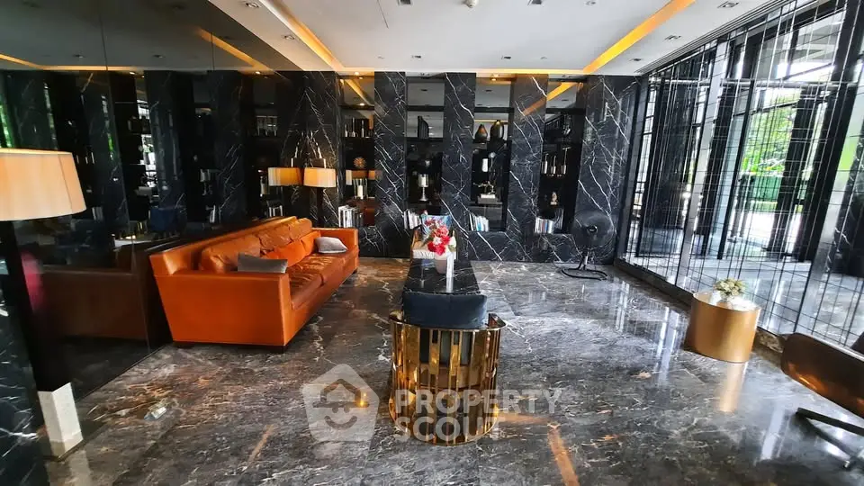 Luxurious modern lobby with marble floors and elegant seating area in upscale building.