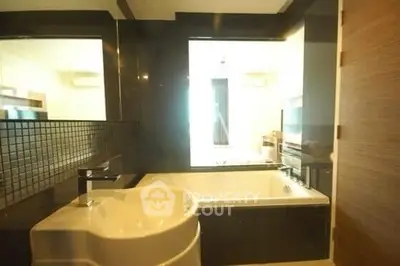 Luxurious bathroom with modern fixtures and spacious bathtub in elegant real estate property.