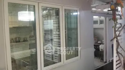 Modern kitchen with large windows and sleek design, perfect for culinary enthusiasts.