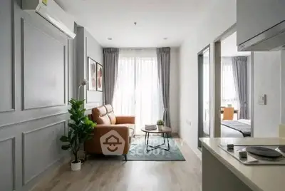 Modern living room with stylish decor and natural light in a contemporary apartment.