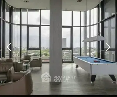 Luxurious high-rise building with panoramic city views and modern lounge area featuring a pool table.