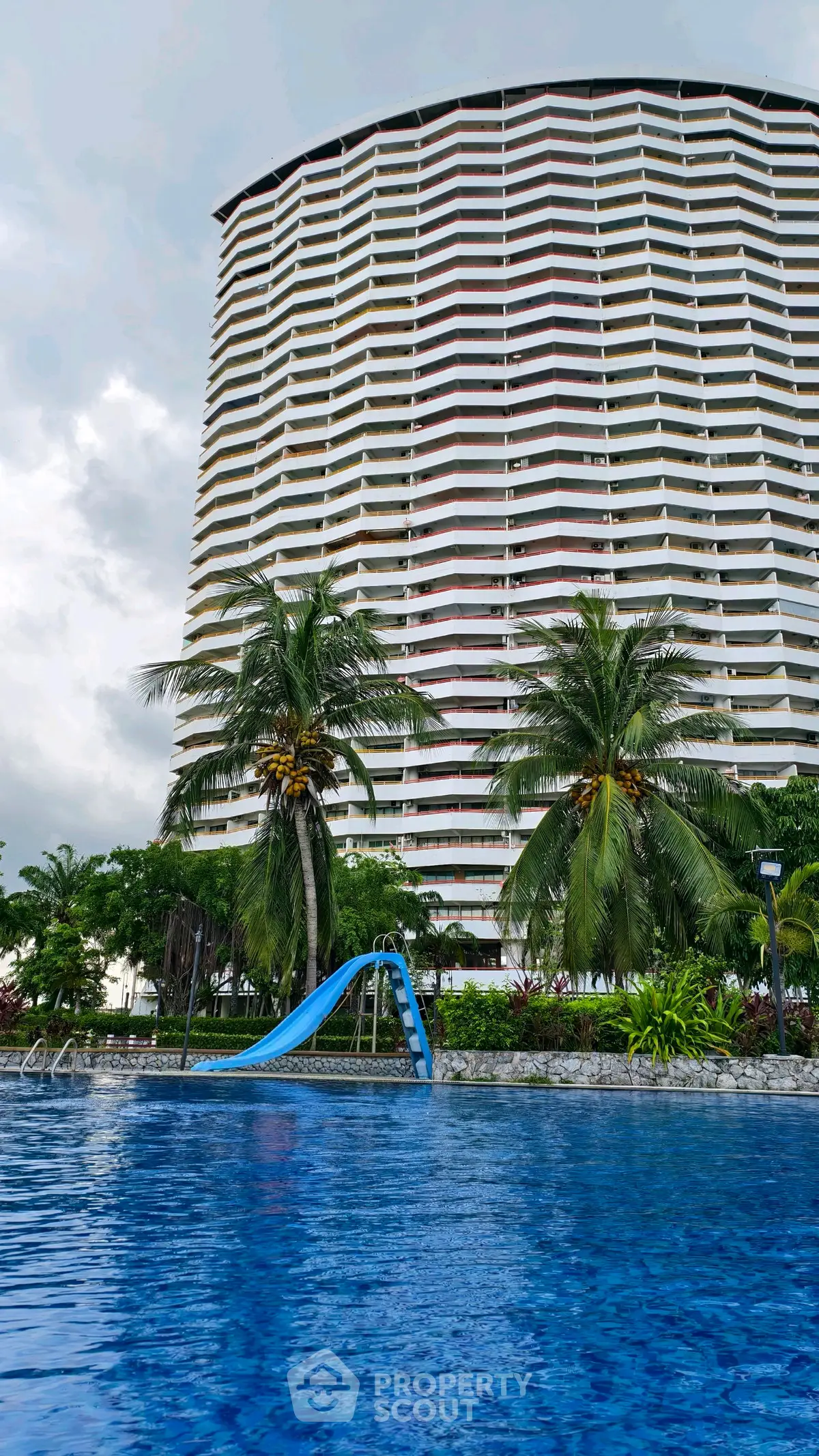 Stunning high-rise building with pool and tropical landscaping