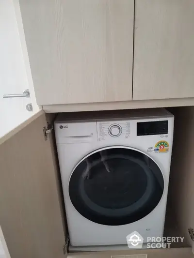 Modern built-in washing machine in sleek cabinetry for efficient laundry space.