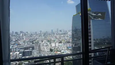 Stunning cityscape view from high-rise balcony with modern architecture.