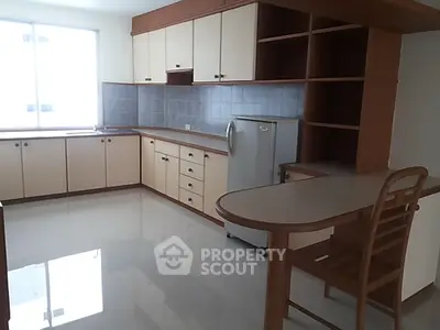 Spacious kitchen with modern cabinetry and breakfast bar in a bright apartment.