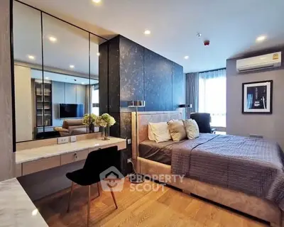 Luxurious modern bedroom with elegant decor and ample natural light.