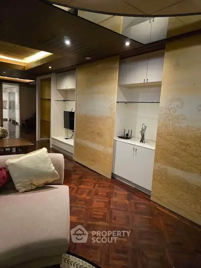 Luxurious living room with elegant wooden flooring and stylish built-in cabinets