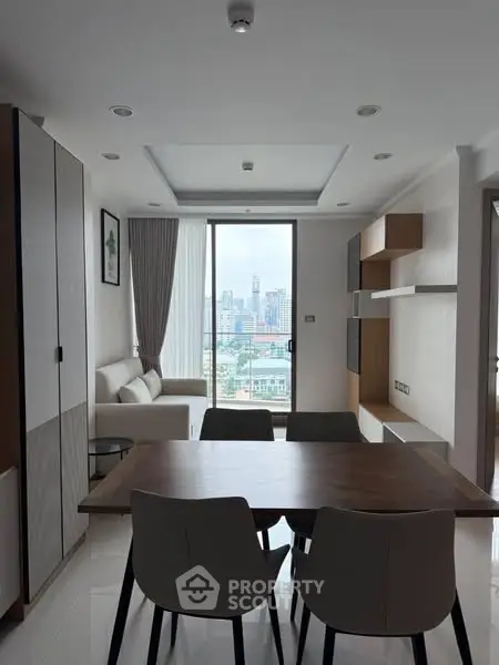 Modern living room with city view, elegant furniture, and natural light.