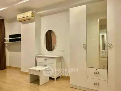 Modern bedroom with elegant white furniture and wooden flooring
