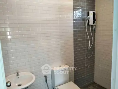 Modern bathroom with sleek tiles and electric shower heater