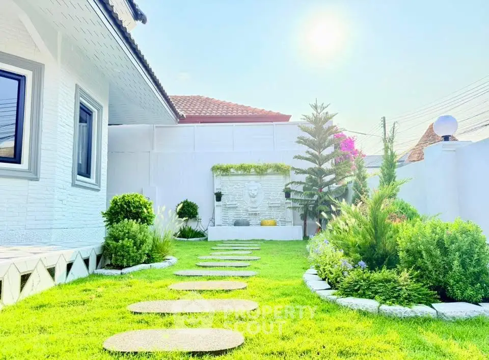 Charming garden with lush greenery and modern landscaping in a serene residential setting.