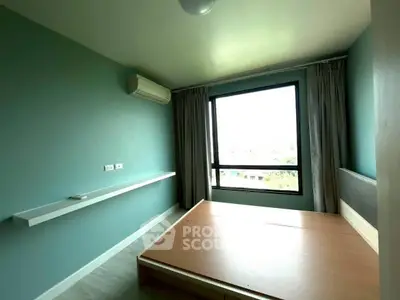 Spacious bedroom with large window and modern air conditioning unit.