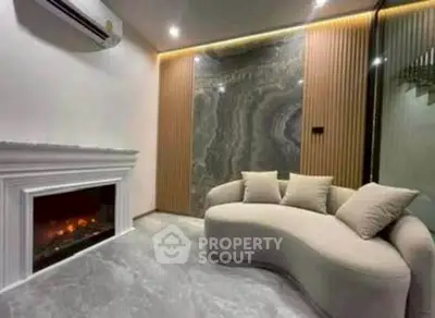 Luxurious living room with modern fireplace and elegant curved sofa