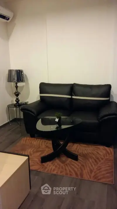 Cozy living room with black leather sofa and modern decor