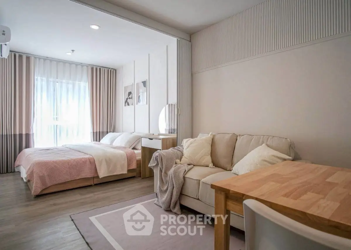 Modern studio apartment with cozy living area and stylish bedroom